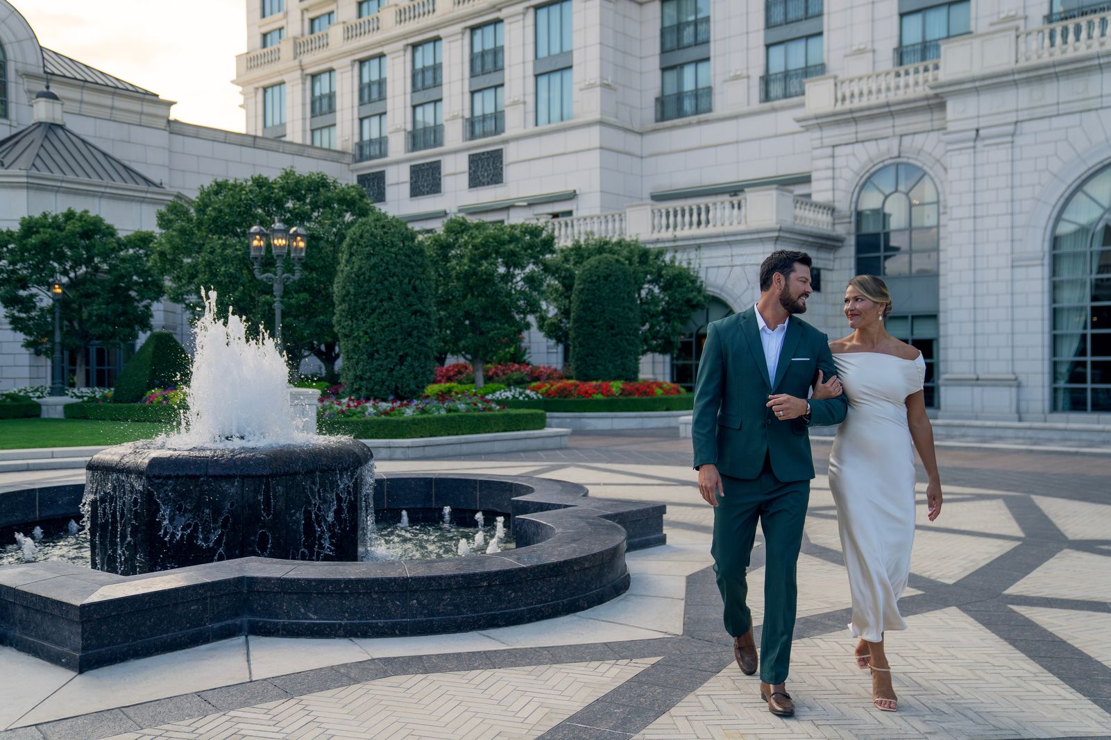 Couple strolling through the Grand America courtyard by the fountain