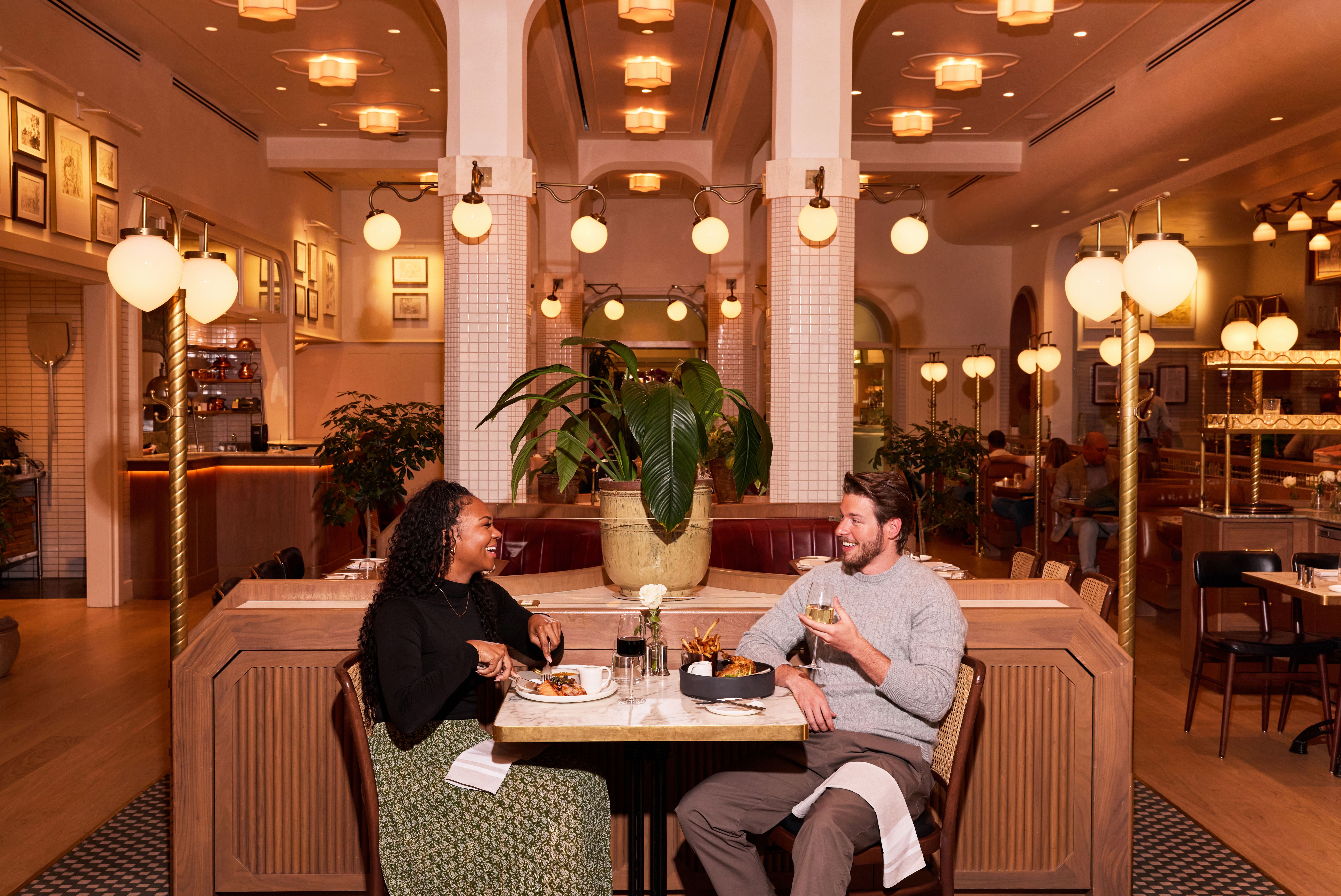 Couple laughing while eating dinner