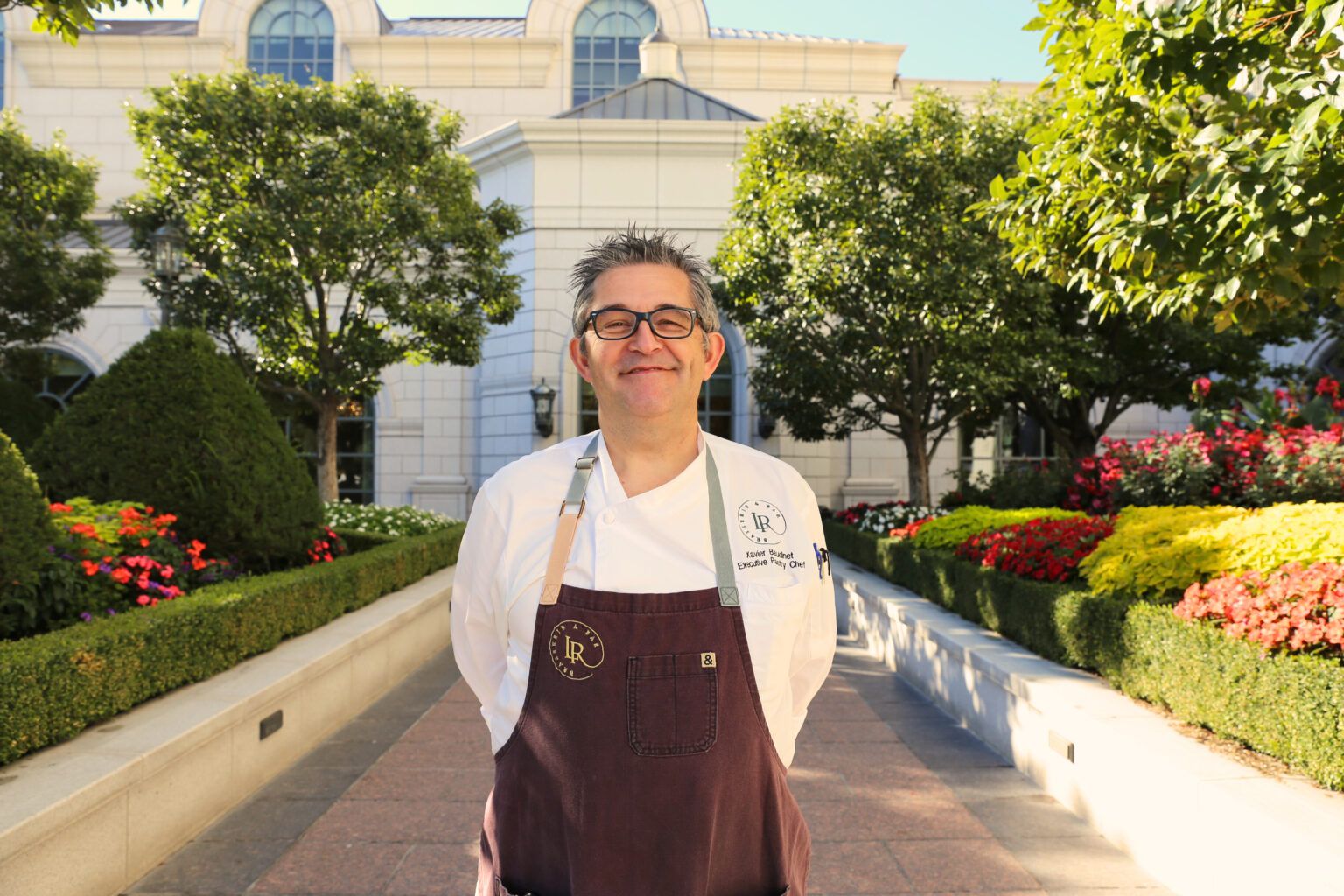 Chef Xavier standing in front of The Grand America Hotel