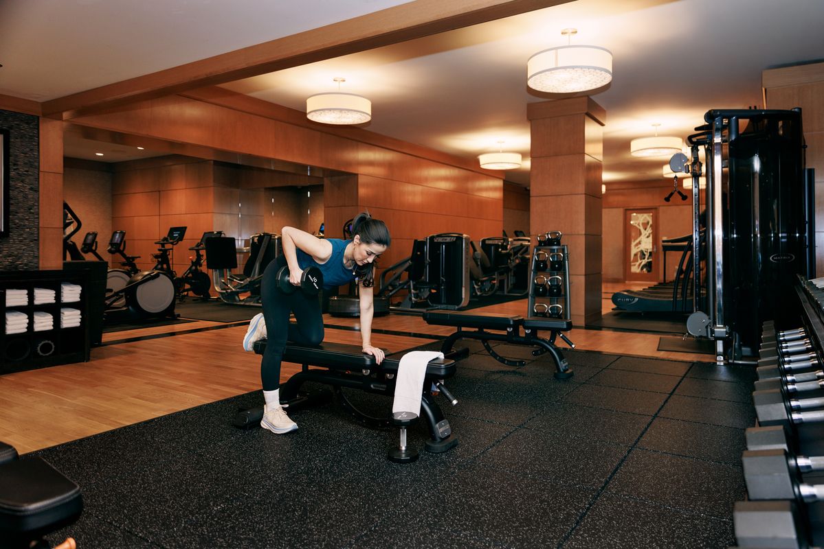 Woman lifting weights in the fitness center