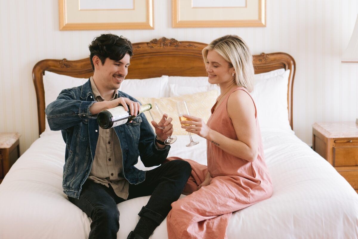 couple pours champagne