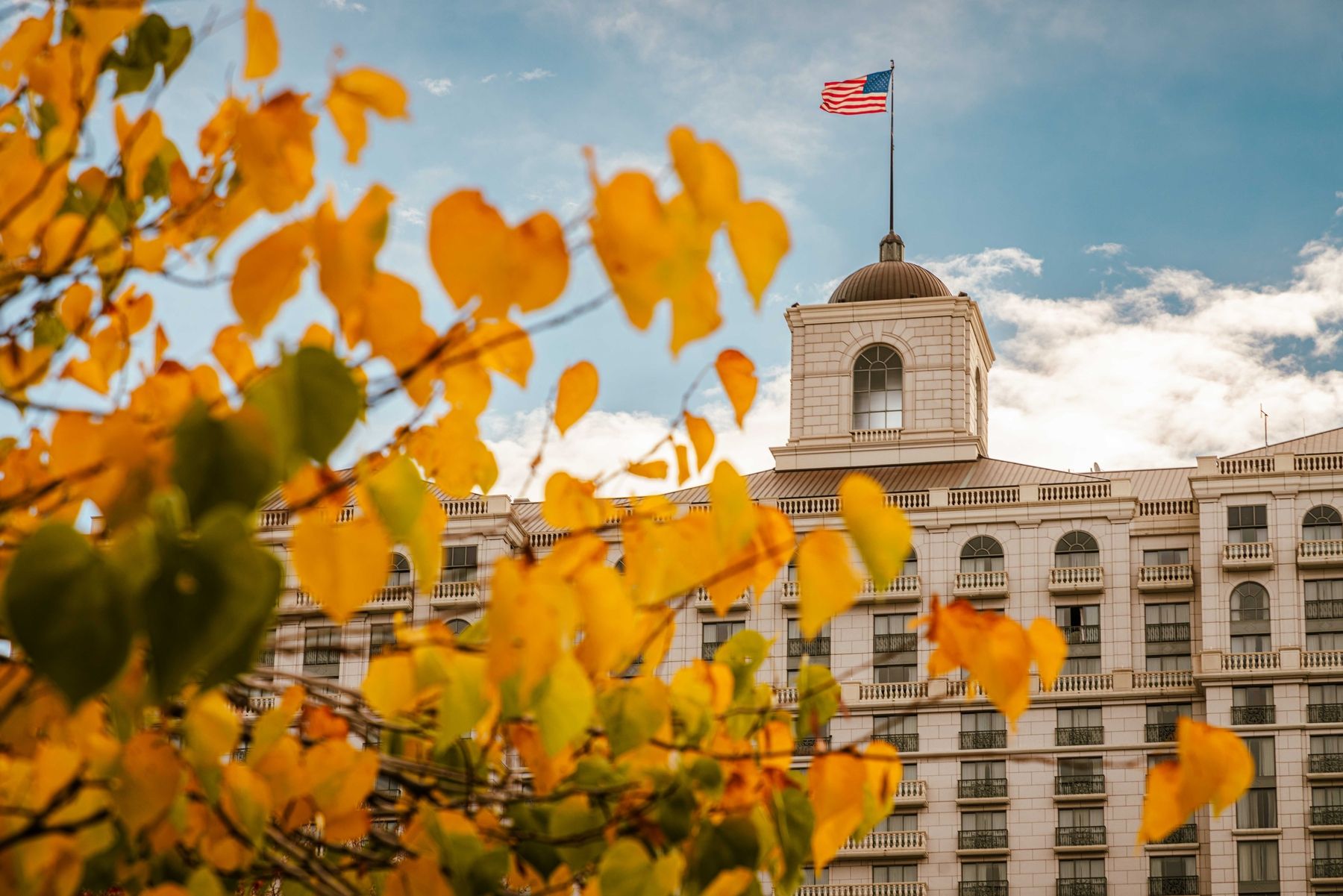 The Grand America hotel exterior with yellow fall leaves