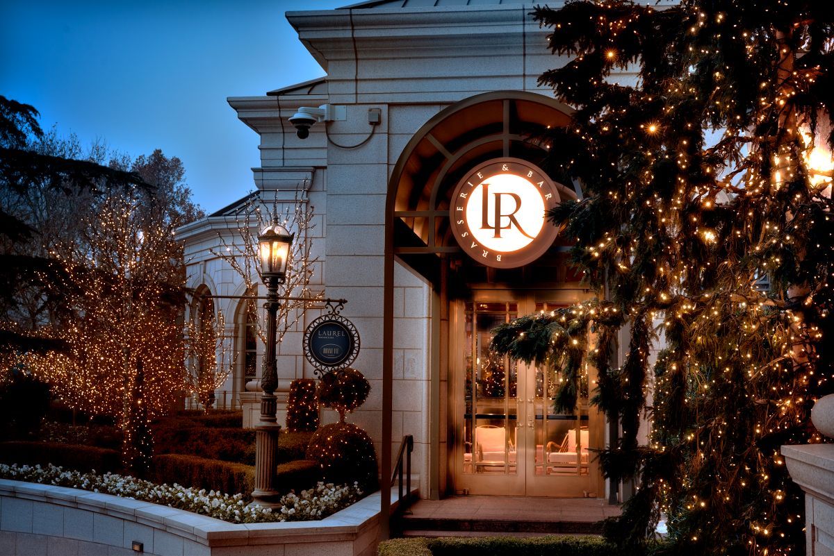 Entrance to Laurel Brasserie & Bar with holiday lights in the trees