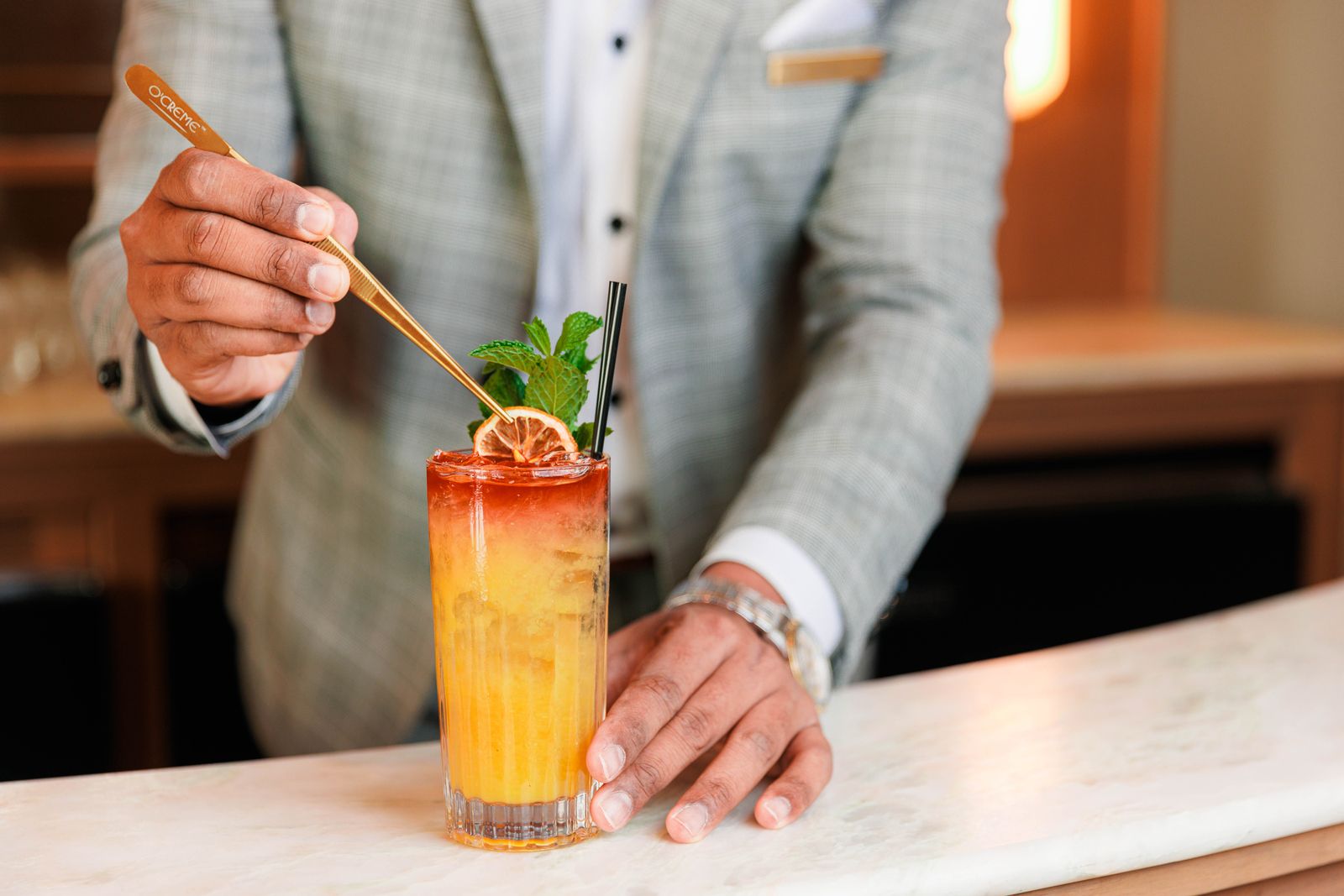 Man stirs a cocktail drink