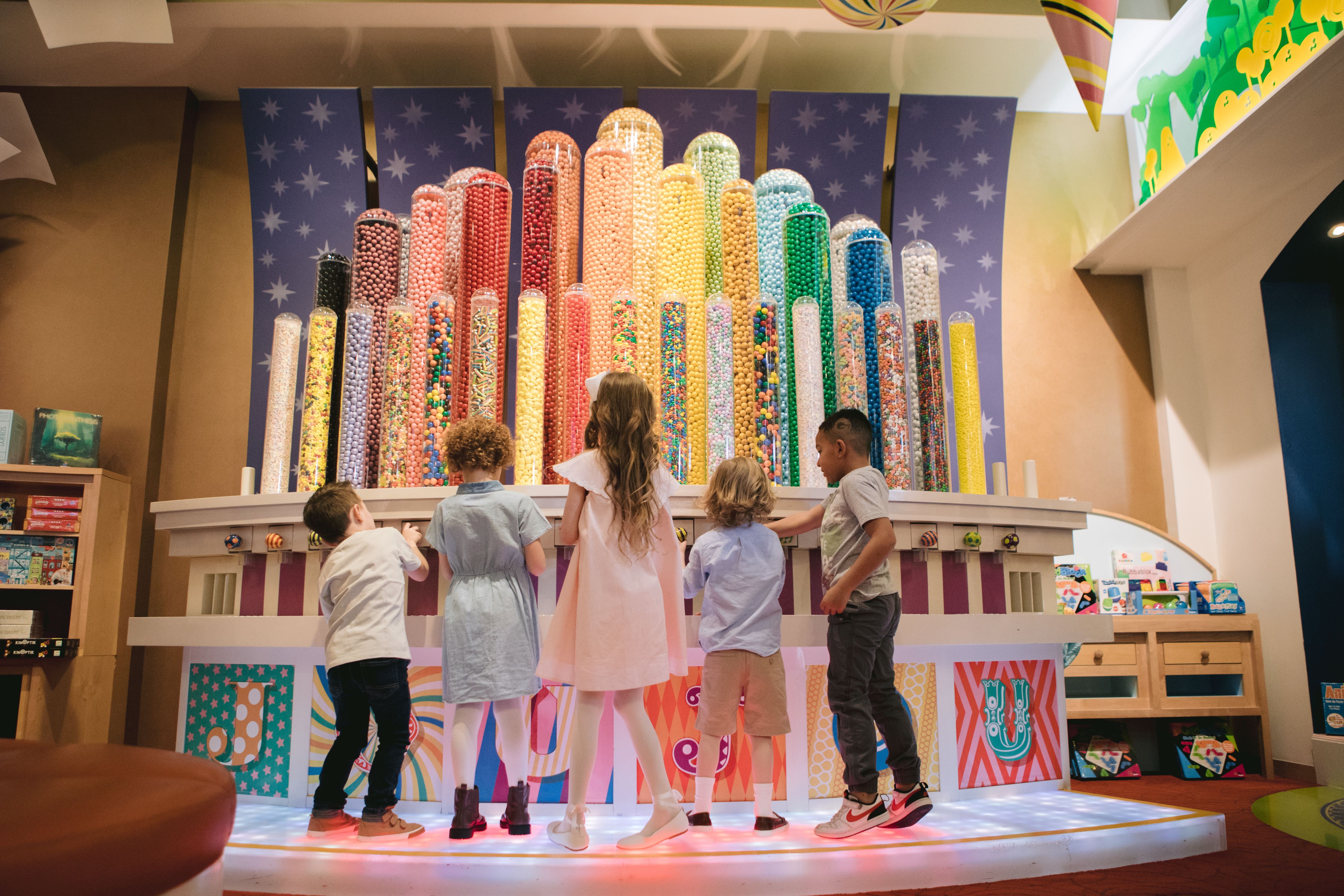 Kids in front of a wall of candy
