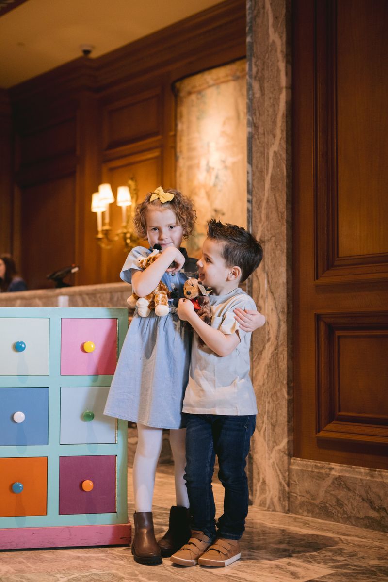 two children hugging in a toy store