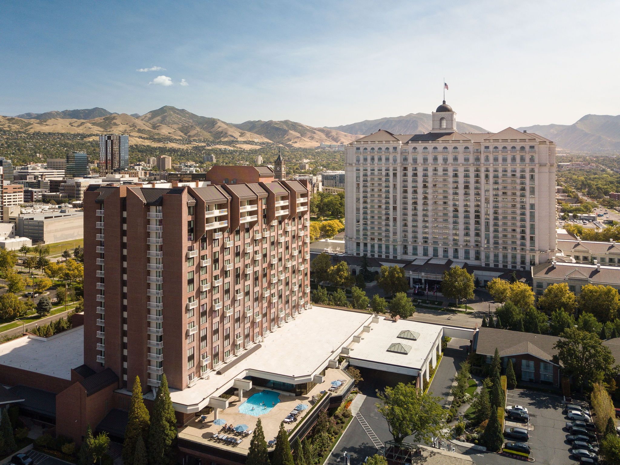 Grand and Little America Hotels against the Salt Lake City skyline and Wasatch Mountains