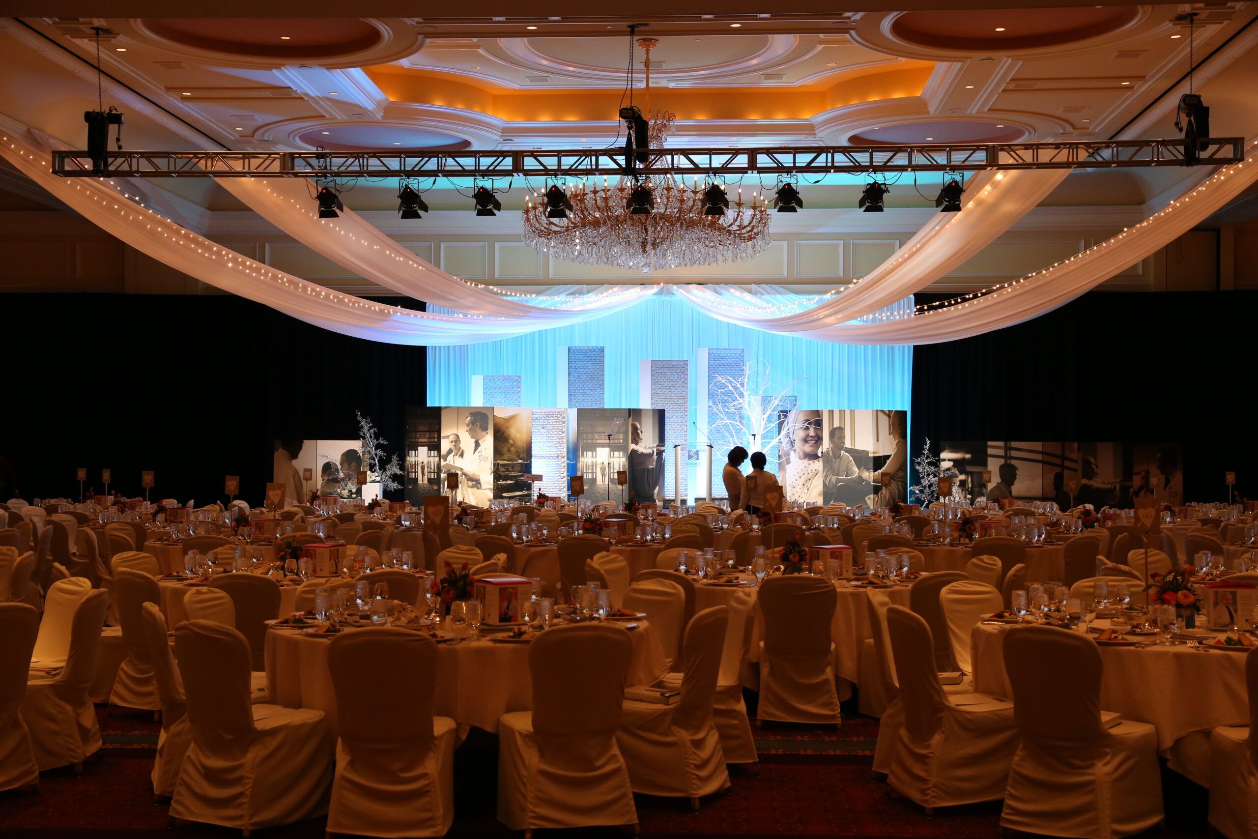 A complete event set-up complete with lighting, seating, displays, and dcor