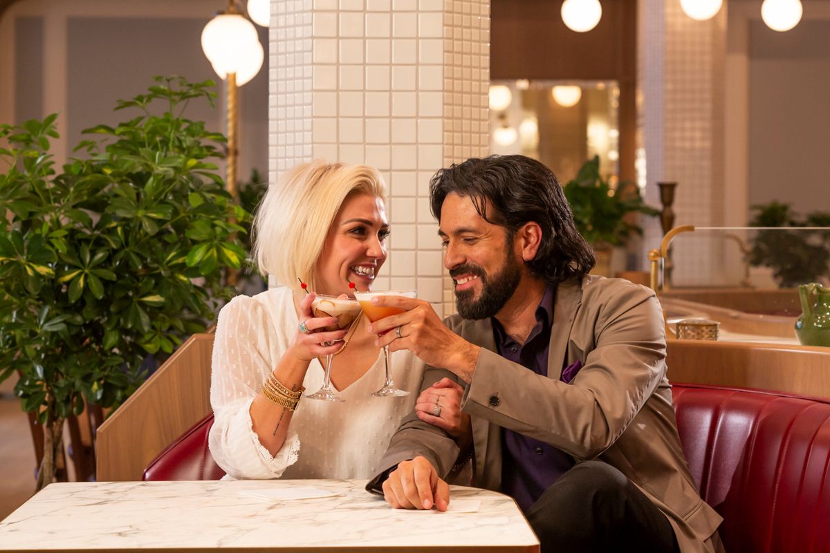 couple doing a cheers with cocktails