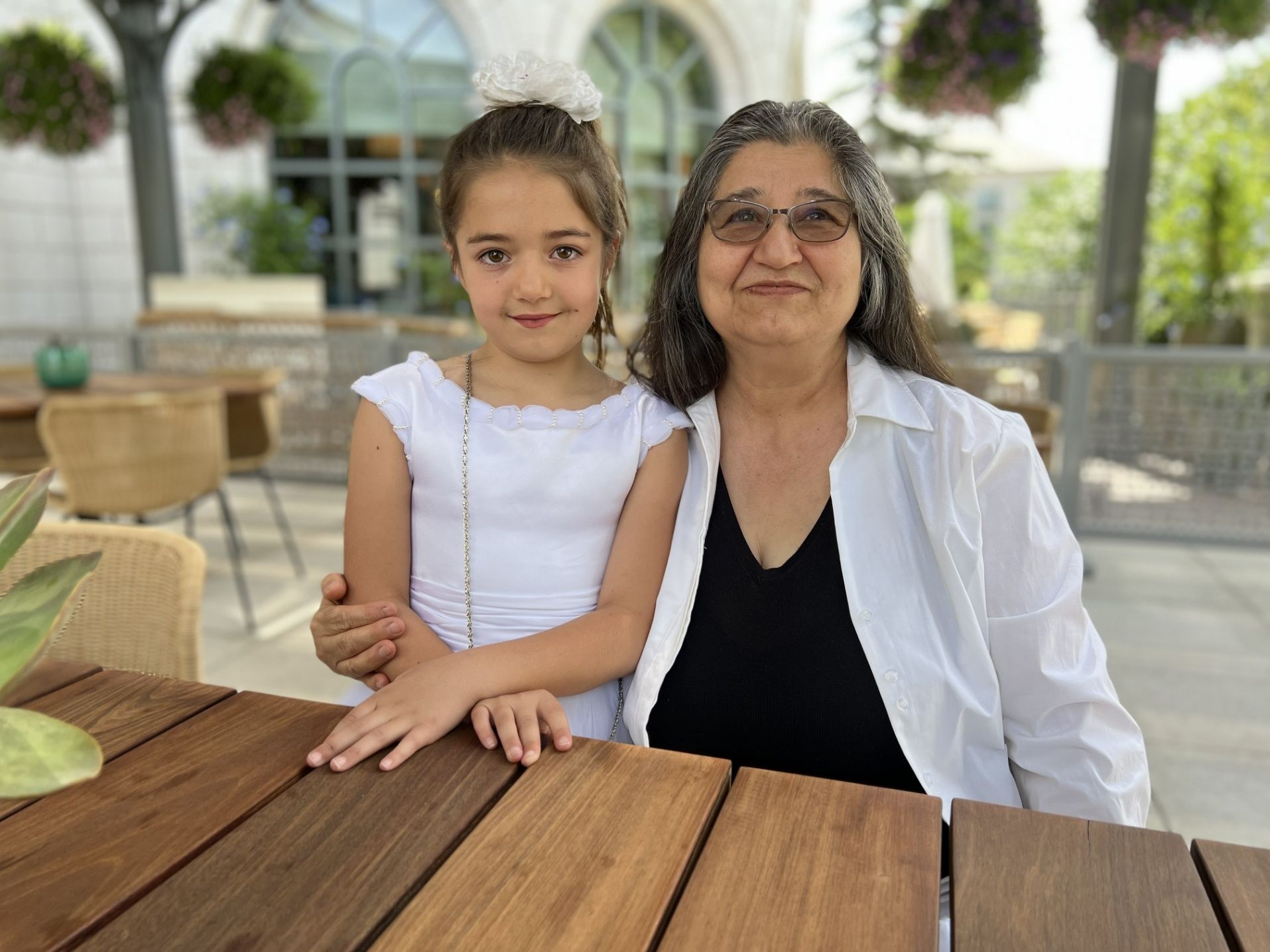 Child and Grandma pose for a photo at the Laurel patio