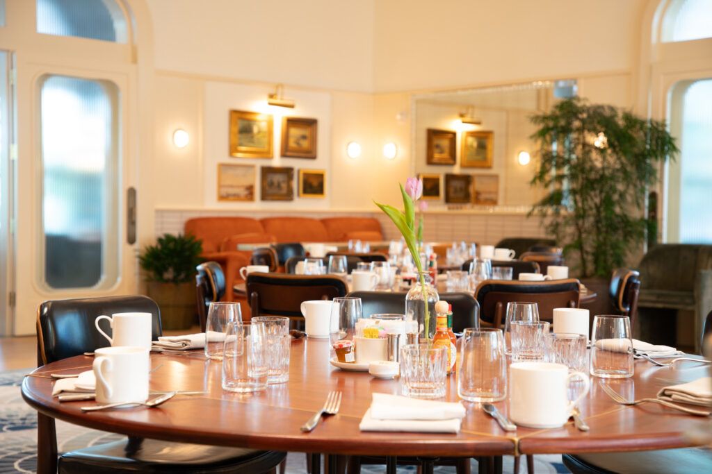 Tablescape with dishes and a tulip in Laurel's Center Room private dining sapce.