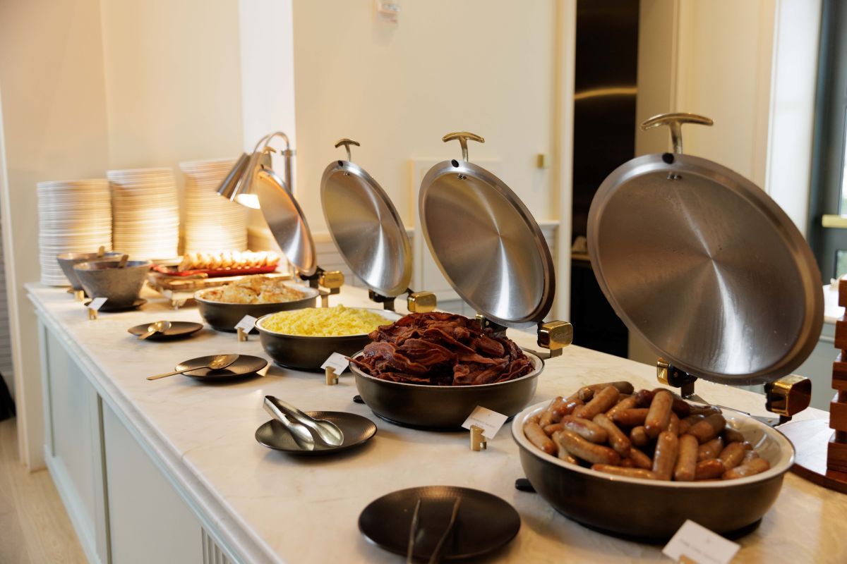 brunch buffet spread of scrambled eggs, bacon, sausage, and other offerings