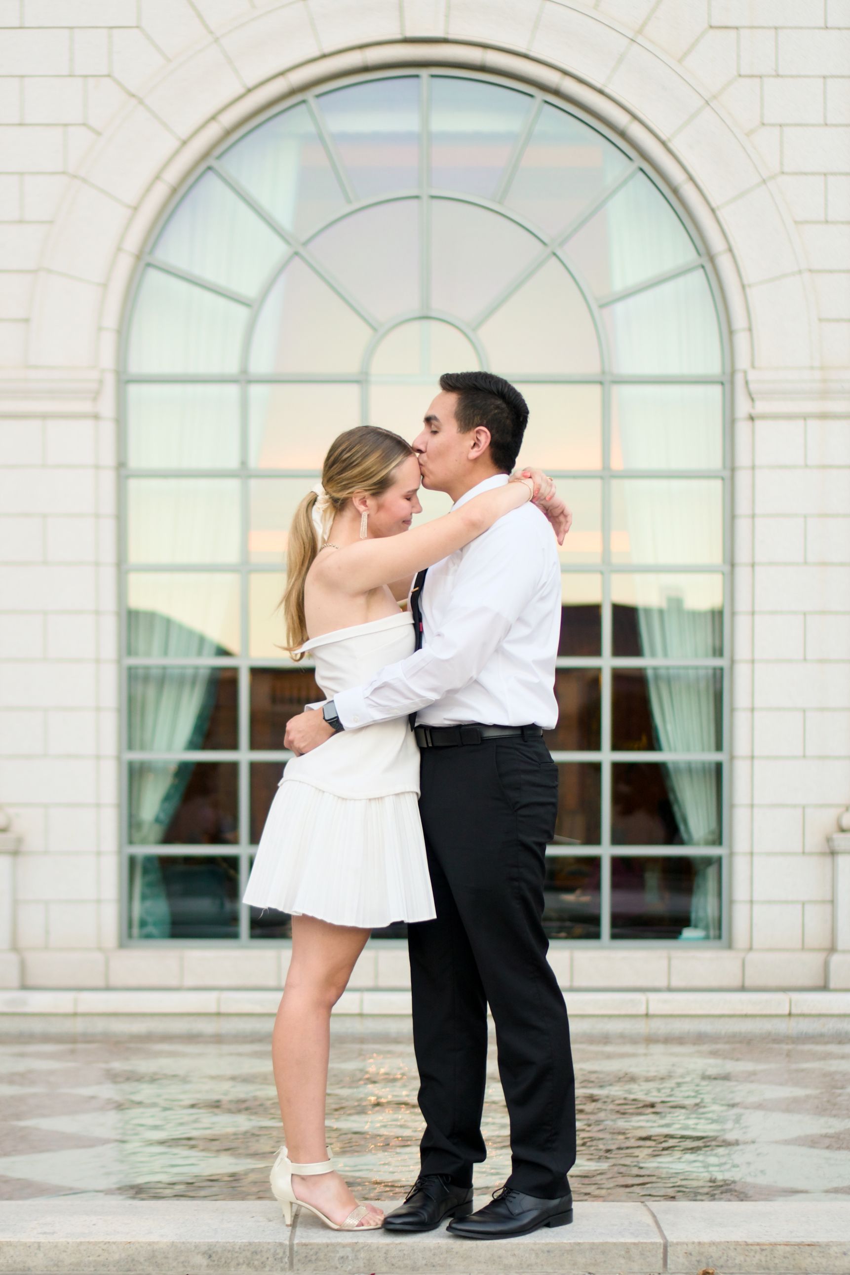 couple posing for a wedding photo in front of the courtyard reflection pool
