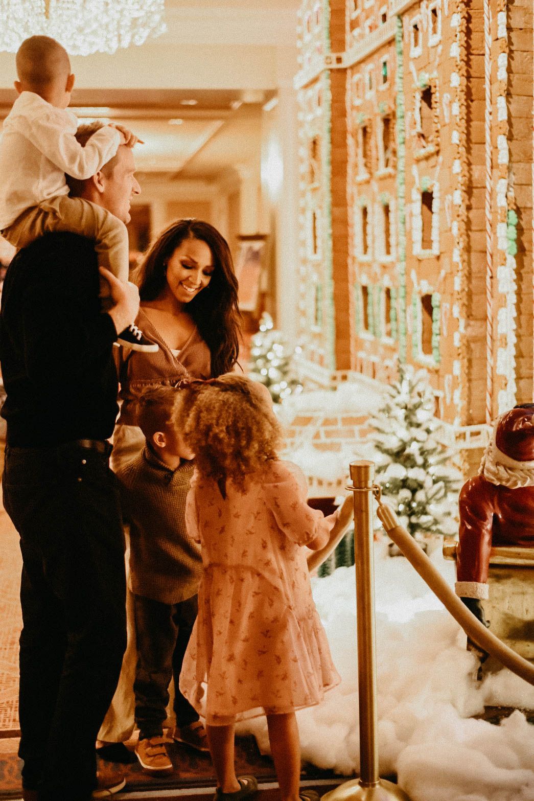 Family admiring the hand built made in house gingerbread house