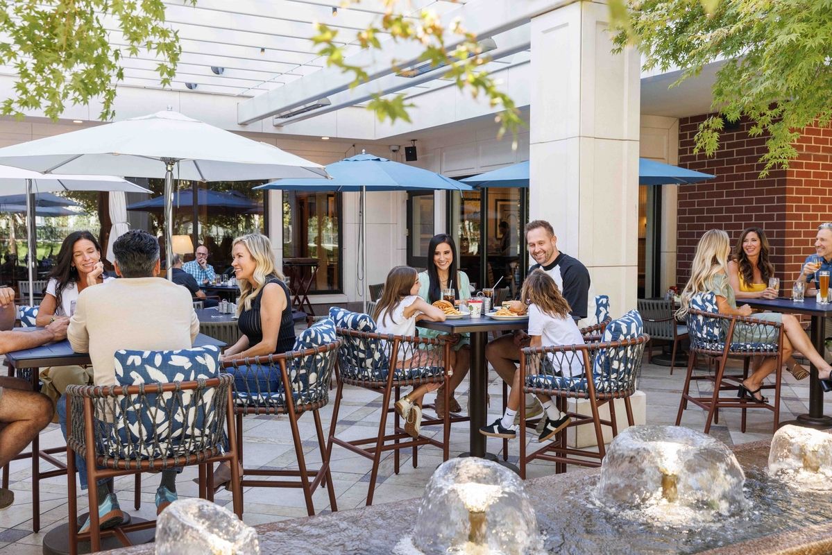 people sitting dining on the outdoor patio of The Coffee Shop at the Little America Hotel in Salt Lake City