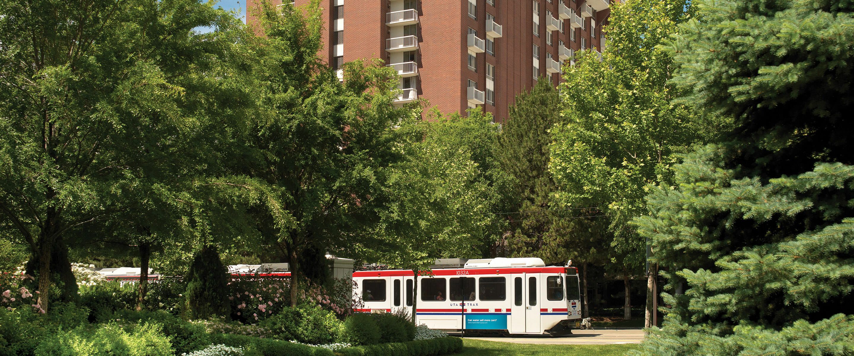 Exterior photo of the Little America Hotel main tower building with light right passing by