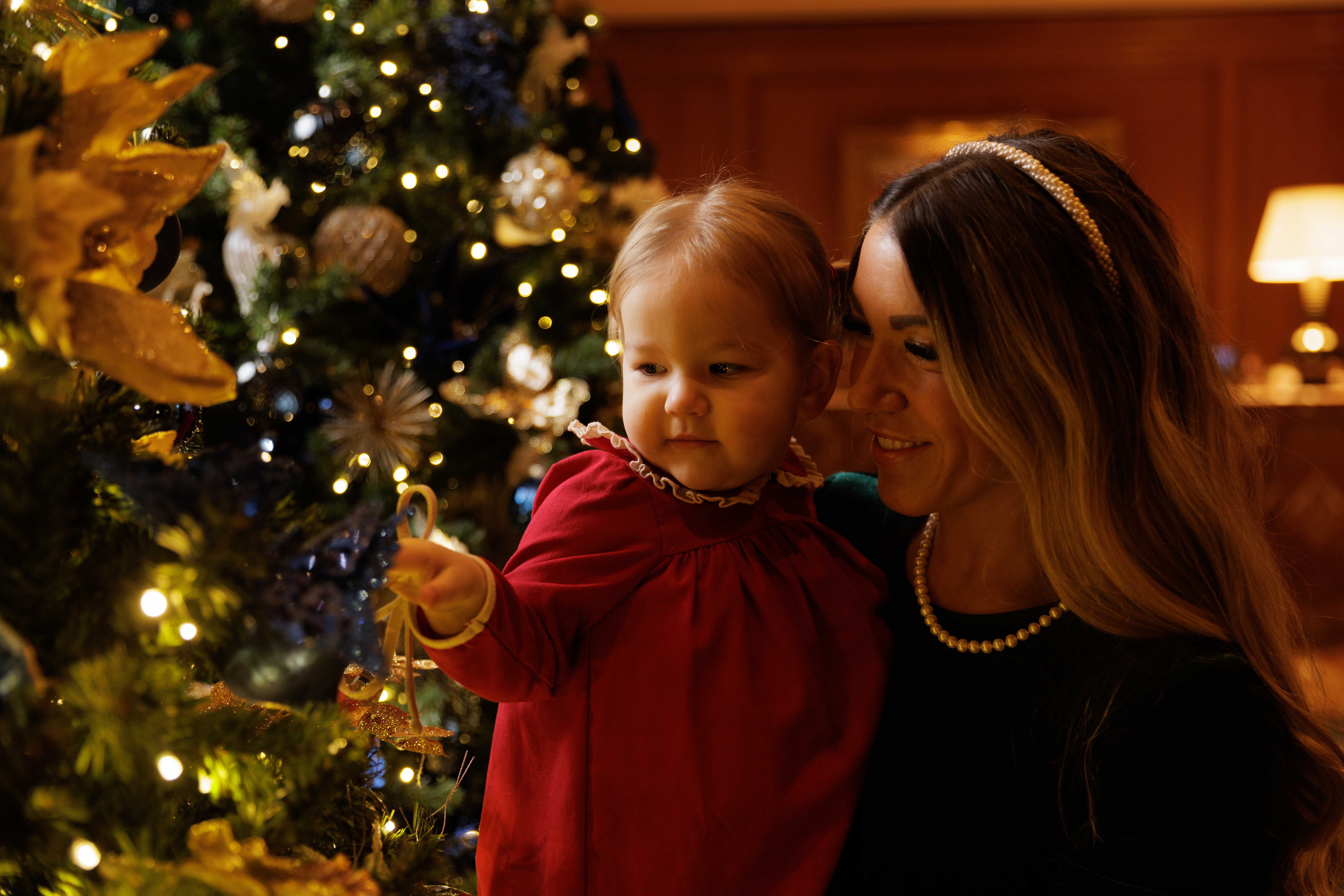 Mother and daughter looking at a Christmas tree