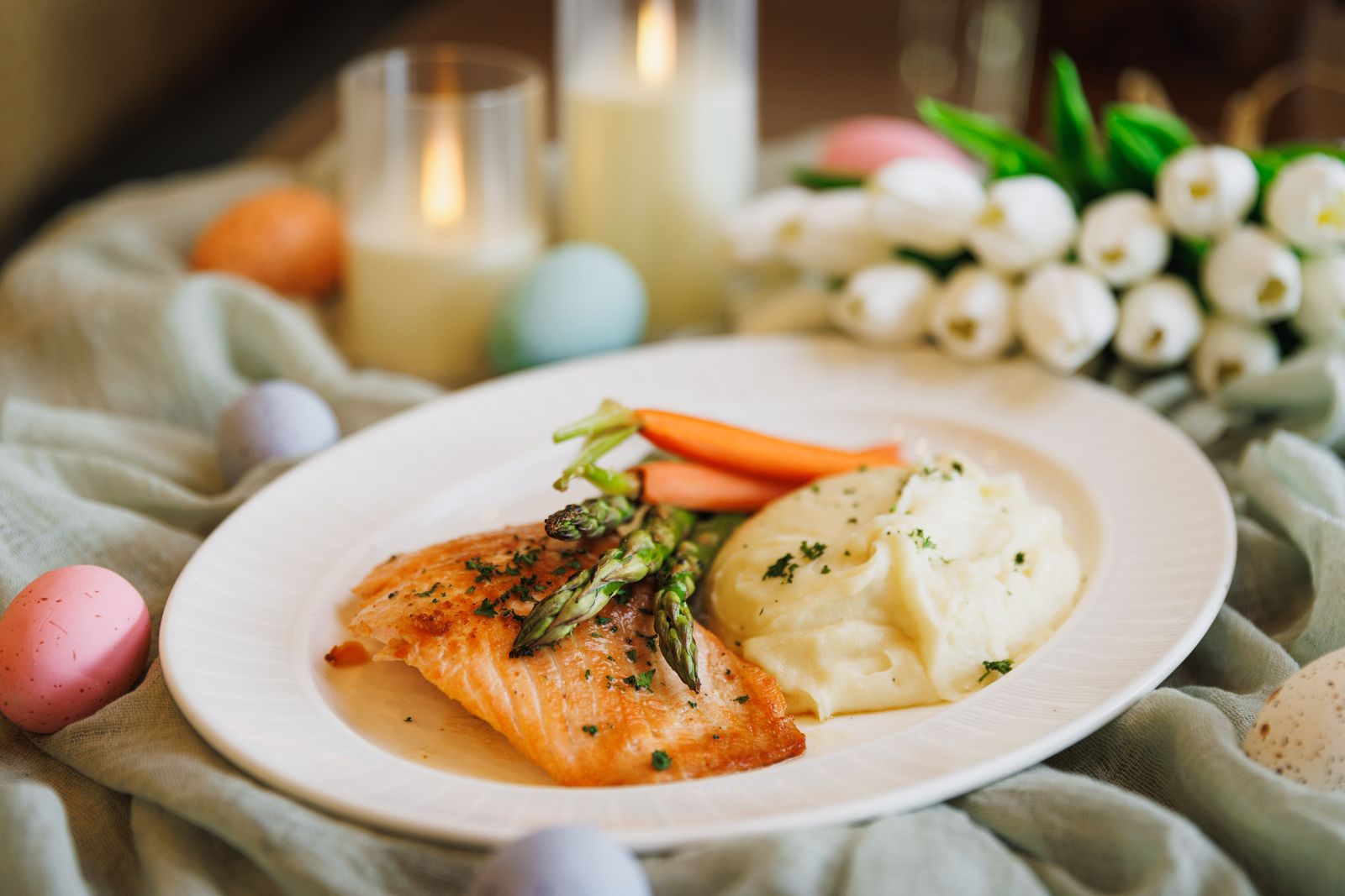 Plate of food including carrots, salmon, asparagus, and mashed potatoes