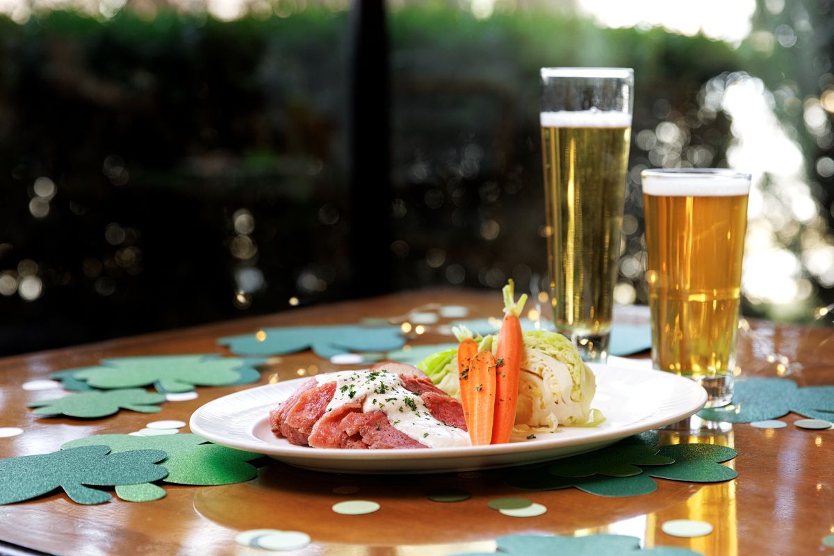 Plate of corned beef and hash on a table decorated for St. Patrick's Day