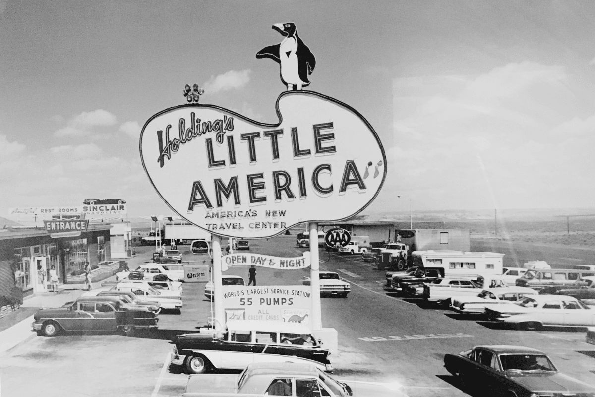 old photo of the little america sign with the penguin at the top