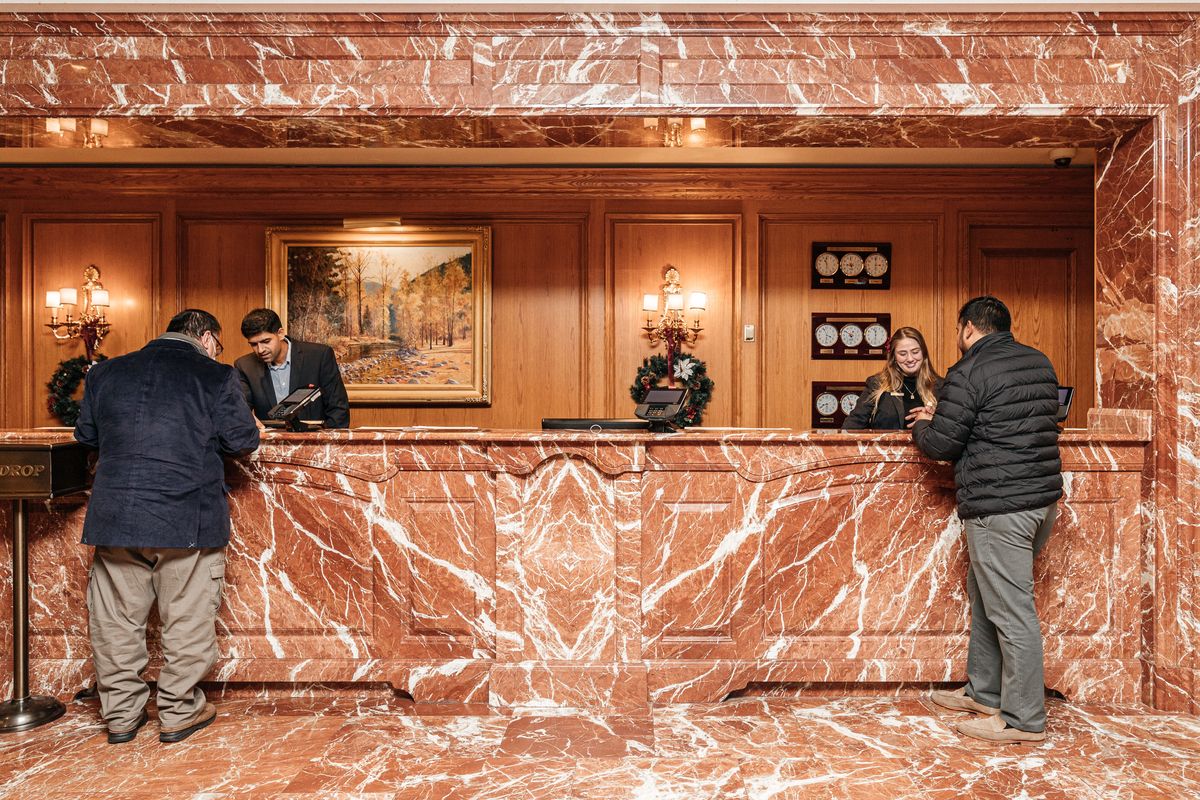 People checking in at the reception desk