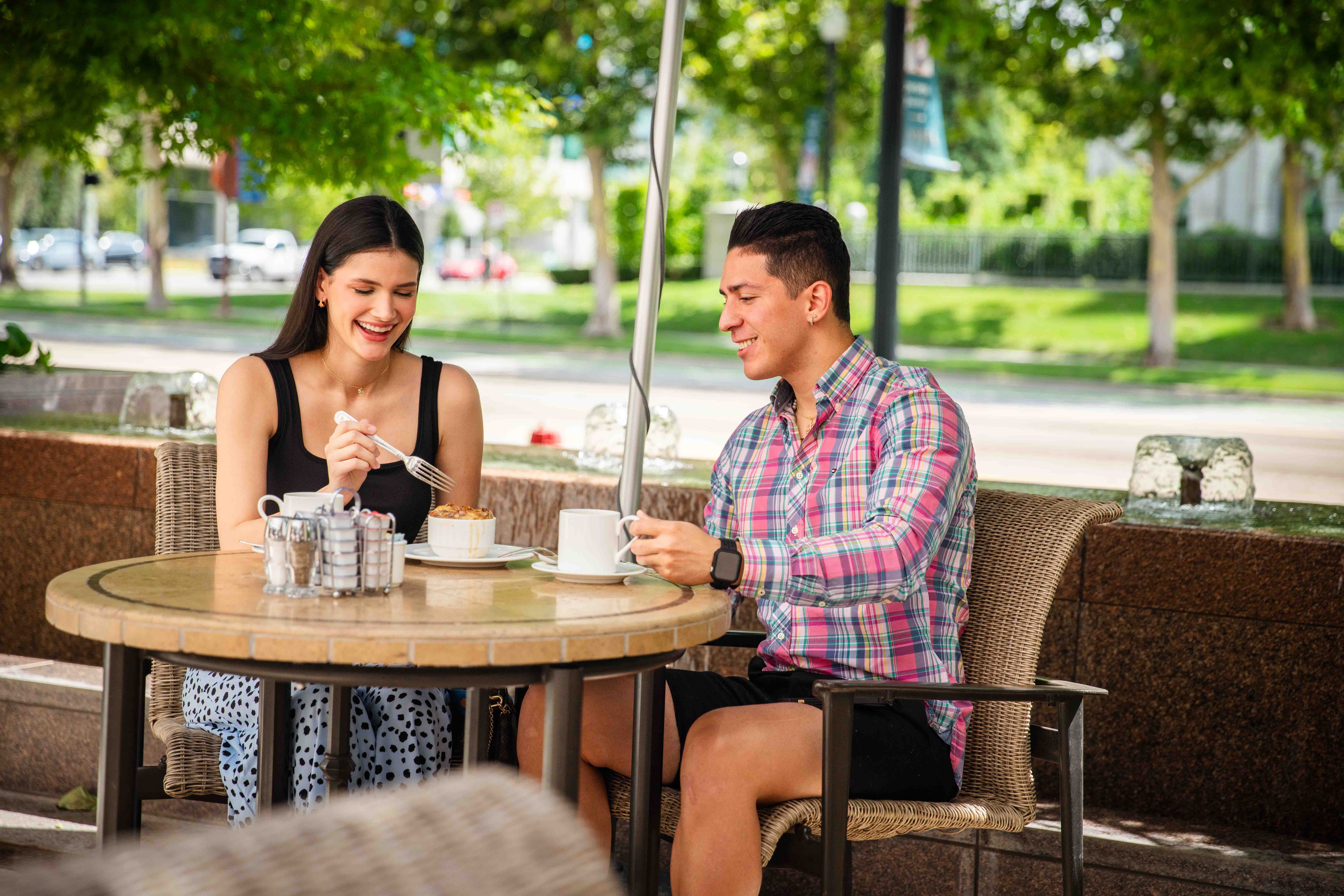 Couple drinking coffee outside